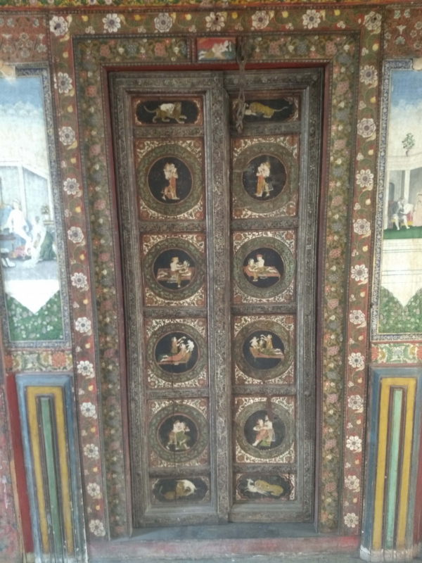 An ornately painted door inside Tambekar Wada.